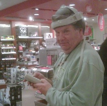 Trying out some weird head-massage gadget in Brookstone.