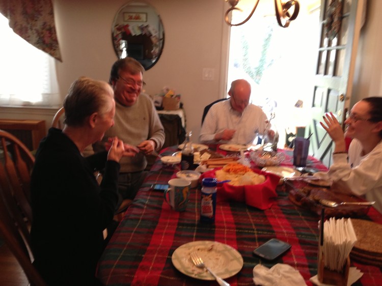 This is the only halfway decent Christmas picture I could get out of these jokers. From left: Mom, Basil, Dad and Catherine, taking the edge off with some snacks before dinner on Tuesday.