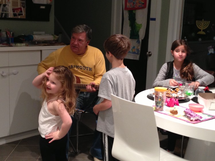 Like riding a bike: To the delight of the kids, Basil remembered some chords. Now we've got to get his guitar down so he can jam with James. From left: Lily, who danced to all the music; Basil; James; and Isabelle.