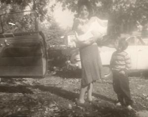 Wish time had been kinder to this photo; we have so few from Basil's childhood. I almost cropped it tightly, but I love the details in the background: the autumn leaves, the sedan door standing open, as though they couldn't wait to catch the moment; the car that's behind them. 