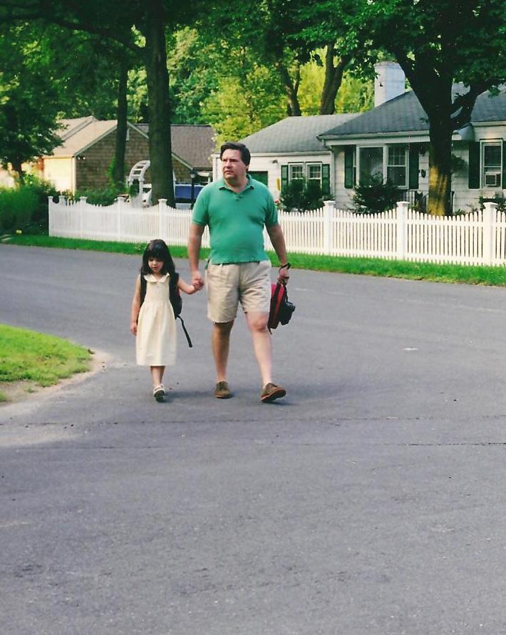 Catherine and Basil walk to the bus stop on the first day of kindergarten.