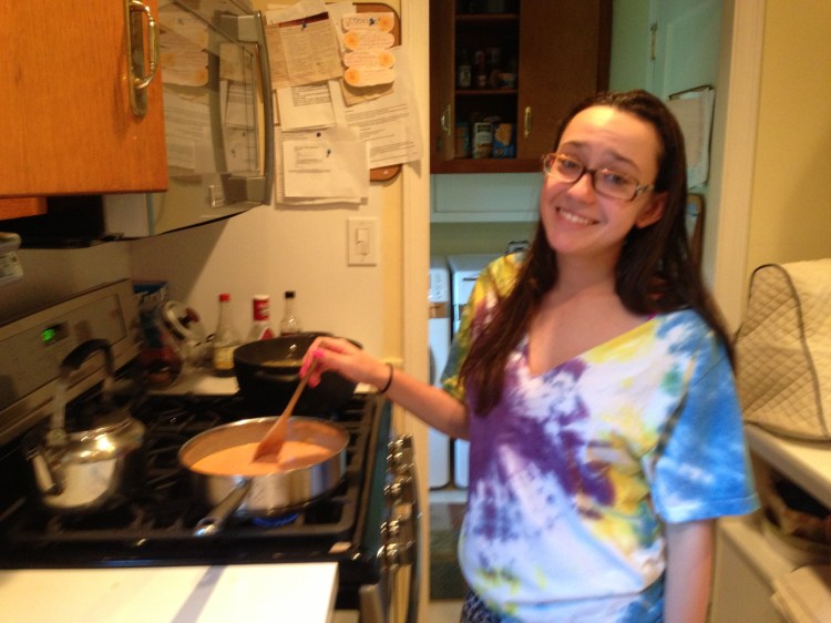 Stirring the vodka sauce.