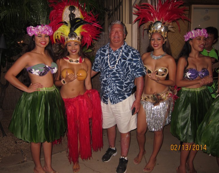 Basil and the hula girls following his turn on stage during the dinner cruise night of the Greenwich High choir's recent trip to Honolulu.