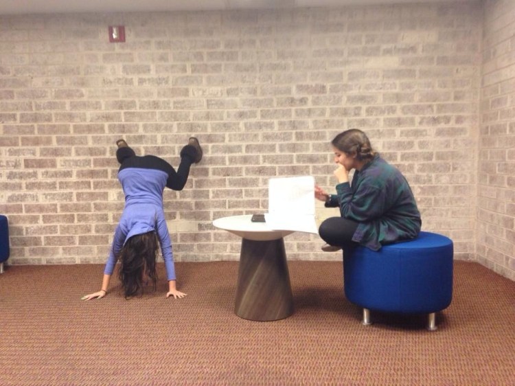 That's Catherine, attempting a handstand in the lounge of her dorm. 